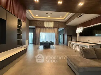 Luxurious open-plan living room with modern kitchen and elegant dining area