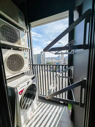 Urban balcony with laundry area and city skyline view