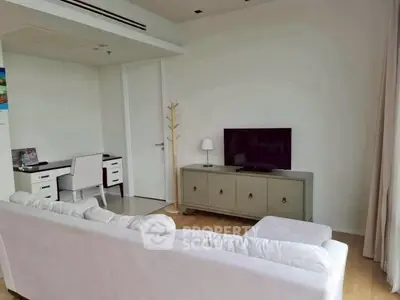 Modern living room with stylish furniture and natural light, perfect for relaxation and entertainment.