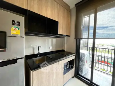 Modern kitchen with sleek cabinetry and balcony view