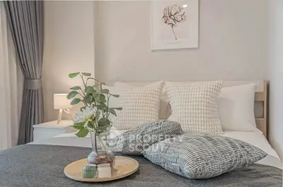 Cozy bedroom with elegant decor and soft lighting, perfect for relaxation.