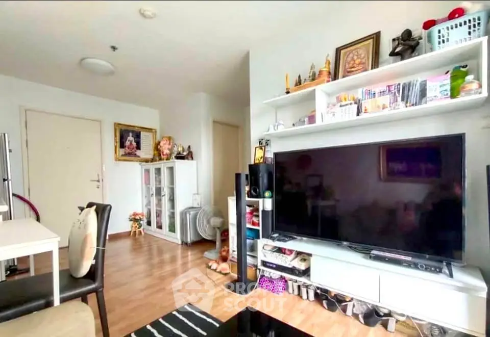 Modern living room with large TV and stylish shelving unit