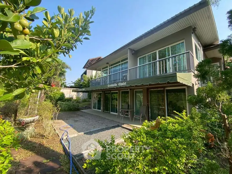 Charming two-story house with lush garden and spacious balcony, perfect for serene living.