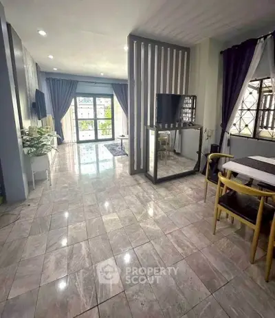 Spacious living room with modern decor and large windows for natural light