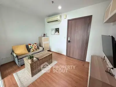Modern living room with cozy sofa, stylish decor, and wooden flooring in a contemporary apartment.