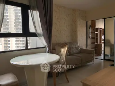 Modern living room with elegant furniture and large window view