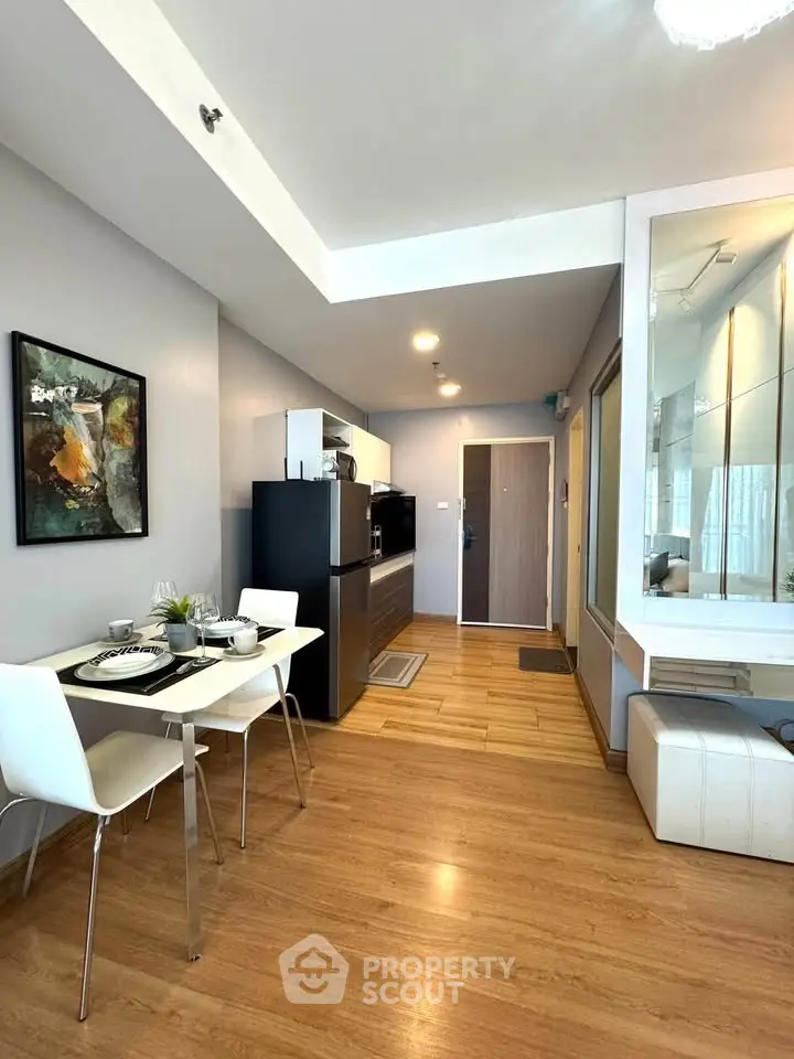 Modern open-plan living area with dining set and sleek kitchen design