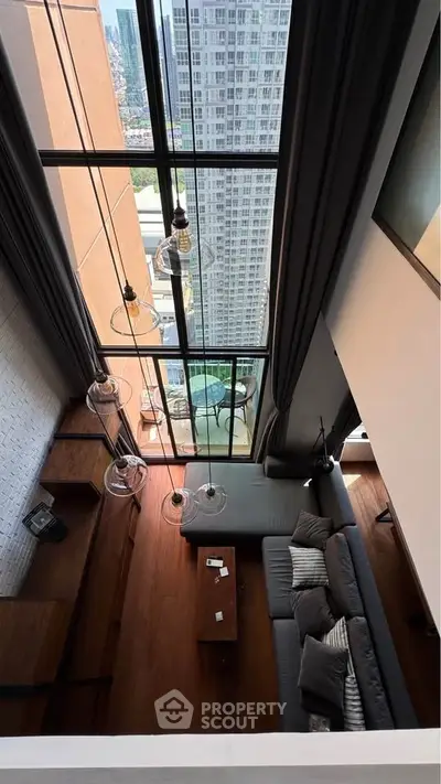 Stunning high-rise living room with floor-to-ceiling windows and breathtaking city view.