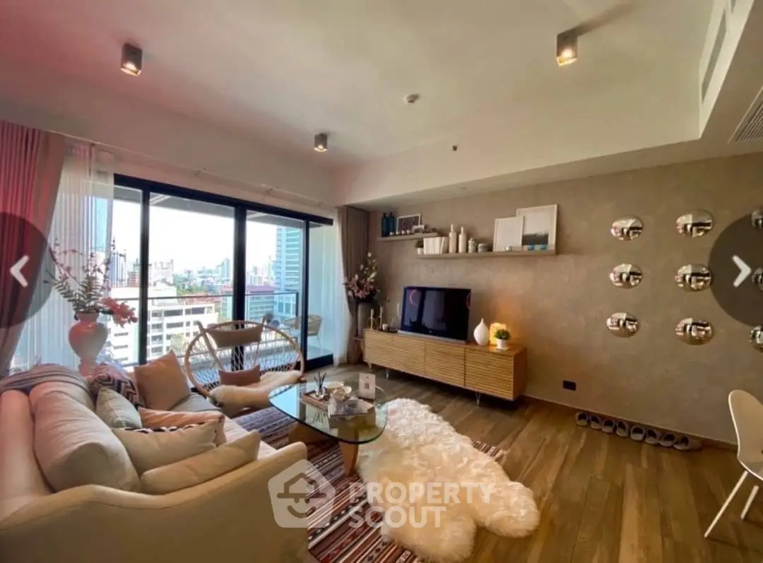 Stylish living room with modern decor and city view, featuring cozy seating and elegant furnishings.