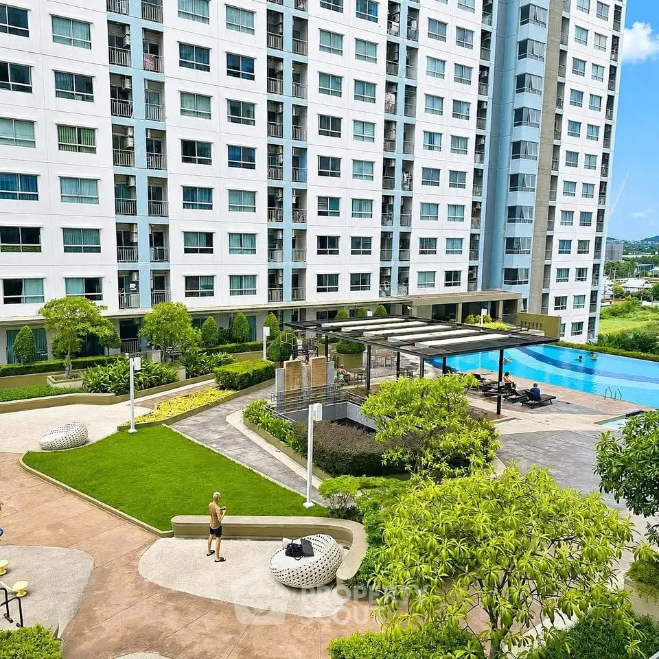 Luxurious high-rise building with pool and landscaped garden, perfect for modern living.