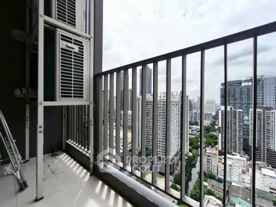 Stunning cityscape view from a high-rise balcony with sleek railing design.