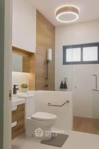 Modern bathroom with sleek design, featuring a circular ceiling light and stylish wood accents.