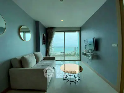 Modern living room with ocean view and stylish decor in a high-rise apartment.