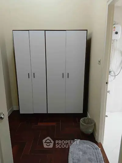 Compact bathroom with modern shower and sleek storage cabinet