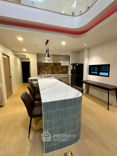 Modern kitchen with sleek island and stylish bar stools in open layout
