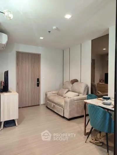 Modern living room with cozy sofa and dining area in stylish apartment