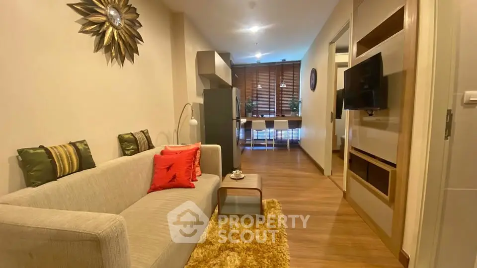 Modern living room with cozy sofa and stylish decor in open layout apartment.