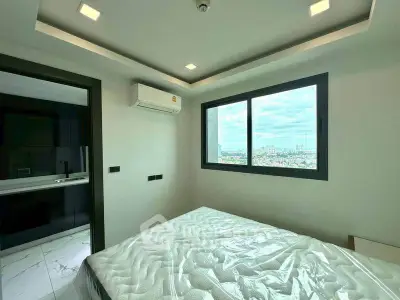 Modern bedroom with city view and air conditioning in high-rise apartment