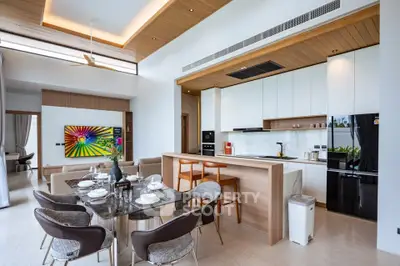 Luxurious open-plan kitchen and dining area with modern design and elegant furnishings.