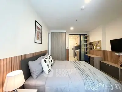 Modern bedroom with stylish decor and in-unit laundry facilities, perfect for urban living.