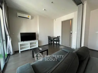 Modern living room with sleek furniture and natural light, perfect for relaxation and entertainment.