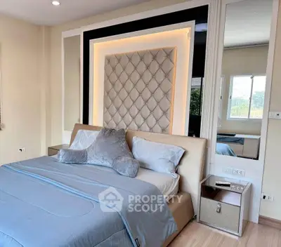 Luxurious bedroom with elegant headboard and modern decor, perfect for relaxation and comfort.