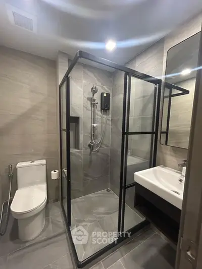 Modern bathroom with sleek shower enclosure and contemporary fixtures