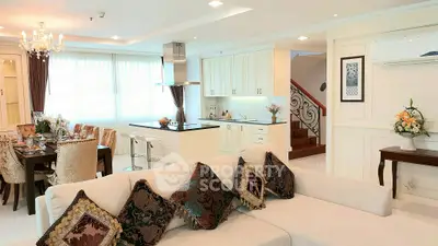Luxurious open-plan living room with elegant dining area and modern kitchen in a sophisticated home.