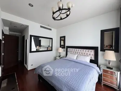 Luxurious bedroom with elegant decor and plush bedding in a modern apartment.