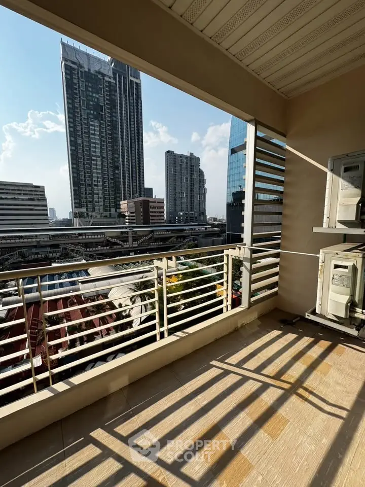 Spacious balcony with stunning cityscape view in modern high-rise building.
