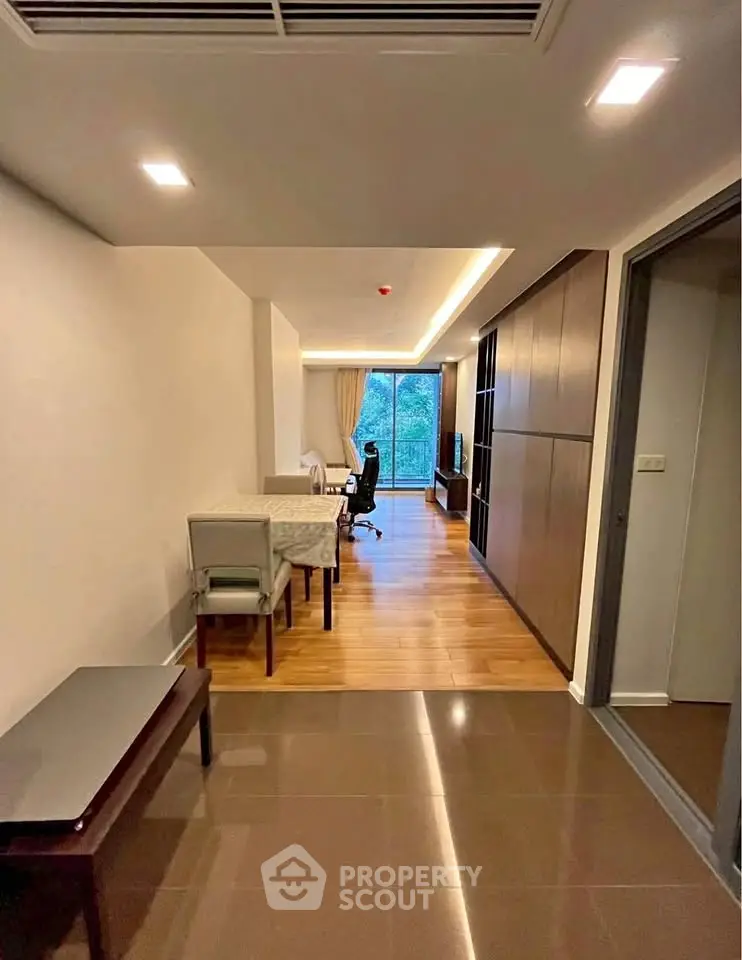 Spacious modern living room with wooden flooring and large window view