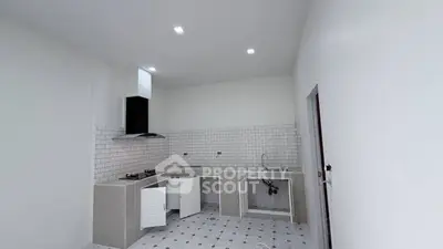 Modern kitchen with sleek design and gas stove in a spacious layout.
