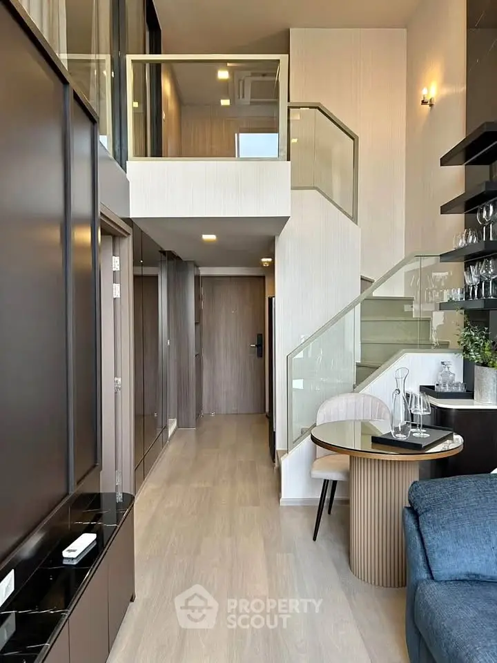 Modern duplex apartment with stylish interior and glass staircase