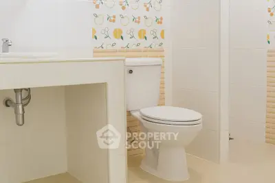 Modern bathroom with decorative tiles and sleek fixtures