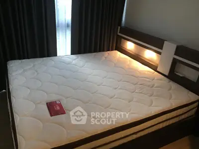 Cozy bedroom with modern bed and ambient lighting, perfect for relaxation.