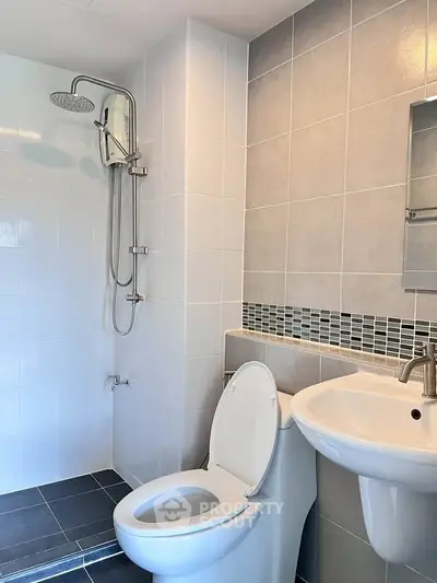 Modern bathroom with sleek shower and stylish sink in contemporary design.