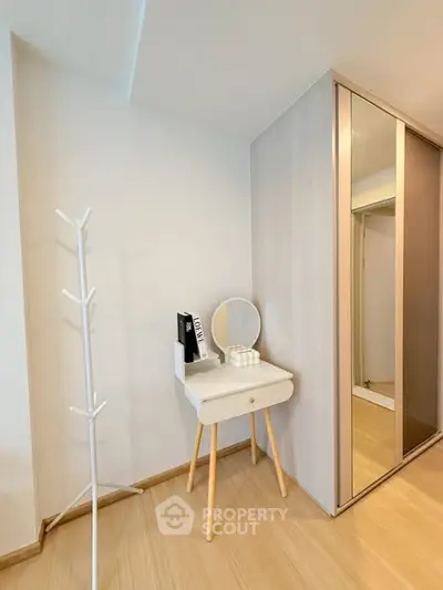 Modern minimalist bedroom corner with stylish vanity and mirrored wardrobe