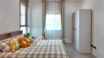 Cozy bedroom with stylish decor and ample natural light