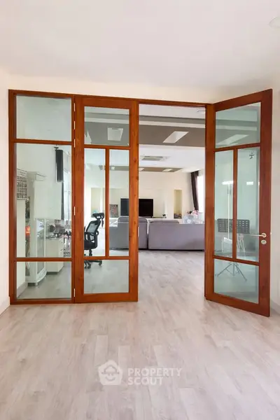 Spacious living room with elegant glass doors and modern furnishings