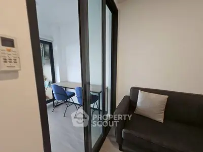 Modern apartment with glass partition and cozy seating area