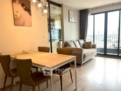 Modern living room with dining area and balcony view in stylish apartment