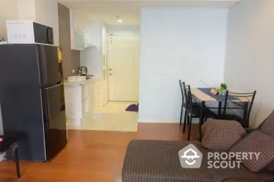 Cozy apartment interior with modern kitchen and dining area, featuring sleek appliances and comfortable seating.