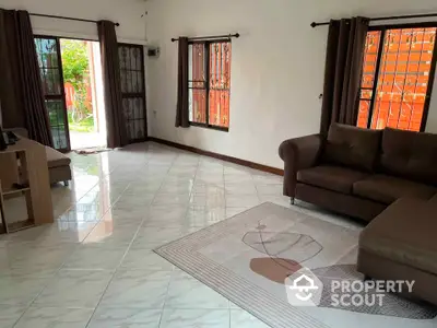 Spacious living room with modern sofa and large windows for natural light