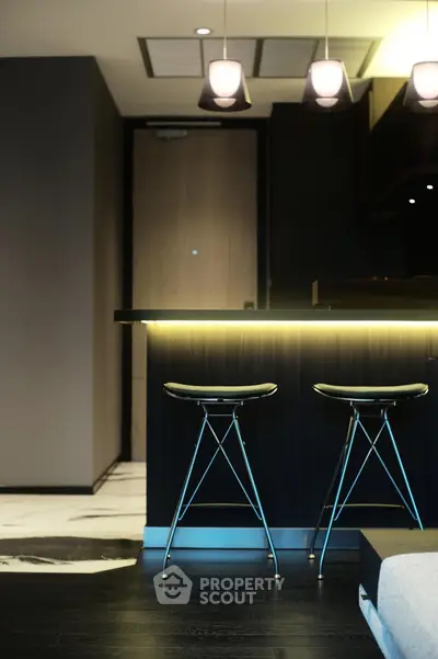 Modern kitchen with stylish bar stools and ambient lighting