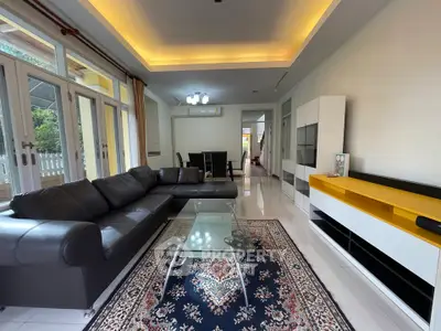 Spacious living room with modern leather sofa and elegant decor in a bright, open layout.