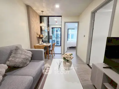 Modern living room with cozy decor and open view to bedroom in stylish apartment