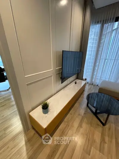 Modern living room with wall-mounted TV and elegant decor