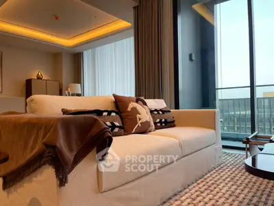 Luxurious living room with plush sofa and panoramic city view, perfect for relaxation and entertaining.