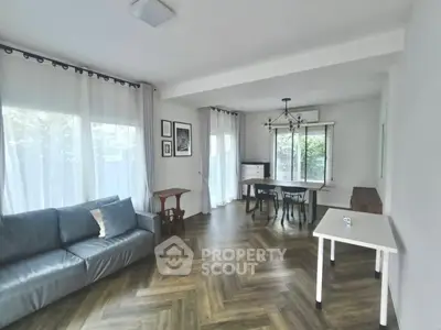 Spacious living room with elegant herringbone flooring and modern decor
