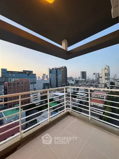 Stunning cityscape view from spacious balcony in modern high-rise apartment.